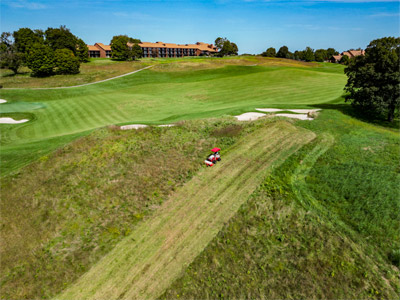 Ventrac Tough Cut - Ventrac is gentle on golf greens but the golf tractor can mow brush too. 