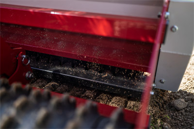 Ventrac Primary Seeder - There is a removable calibration tray to easily adjust to different grass seed types.