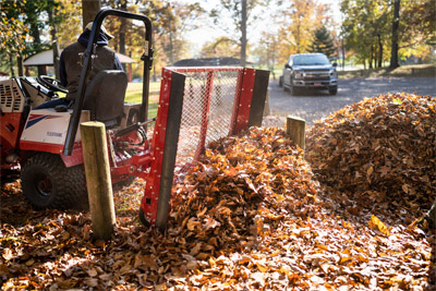Ventrac Leaf Plow - The EF300 Leaf Plow pushing leaves. No more hassle of falling behind using a blower.