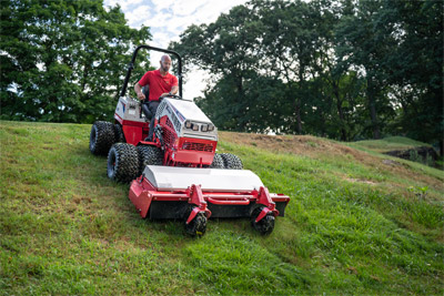 Ventrac 4520 - The Ventrac 4520 maintains precise control while descending a steep slope, thanks to its low center of gravity, performance-engineered tires, and weight transfer system, ensuring efficient operation on challenging terrains.