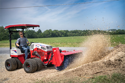 Ventrac Broom - Brushing woodchips back into the hole.