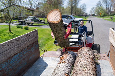 Log Grapple - The Ventrac Log Grapple loading a log into a trailer bed with ease.