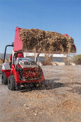 Light Material Bucket - The Ventrac Light Material Bucket full of mulch in the lifted position.
