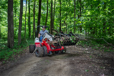 Ventrac Loader - The Ventrac KM500 Loader demonstrates exceptional maneuverability as it weaves on and off wood trails. This versatility, combined with the Ventrac 4520’s turf-friendly design, ensures efficient trail clearing while navigating tight spaces with ease.