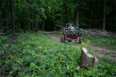 Ventrac Loader - Clearing wood trails is a breeze with the Ventrac KM500 Loader, designed to maximize the capability of the Ventrac 4520. Its easy installation and operation, combined with a dual-wheeled tractor for minimal ground impact, make it an ideal choice for efficient trail maintenance.