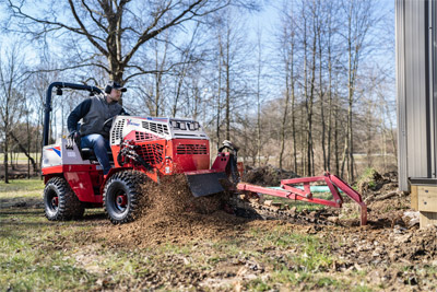 Ventrac Trencher - Close quarters mastery – Ventrac Trencher gets up close to buildings, showcasing its ability to work with precision in tight spaces, making it an ideal choice for utility installations near structures.