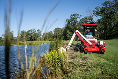 Ventrac Boom Mower - Unleashing efficiency with Ventrac Boom Mower – effortlessly taming tall grasses along the pond's edge, this powerful attachment saves time and effort, sparing the need for manual labor, and ensuring a pristine landscape without breaking a sweat.