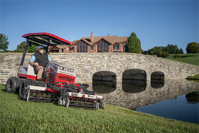 Ventrac Reel Mower - The Ventrac MR770 Reel Mower effortlessly trims along water features on a golf course, boasting a 77-inch cut width and variable speed hydraulics. Designed to handle slopes up to 30 degrees, it provides a superior finish even in challenging terrains.