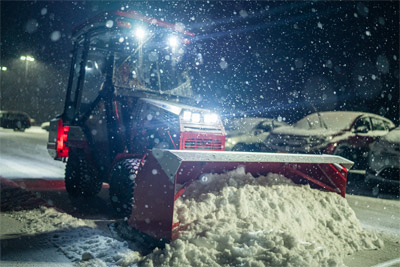Ventrac Box Plow - The Ventrac 4520 combined with the Box Plow conquer snow-covered parking lots, effortlessly moving around obstacles and ensuring business as usual.