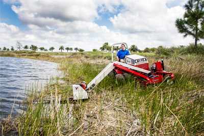 Ventrac Boom Mower - Mowing over a pond with the MA900. 