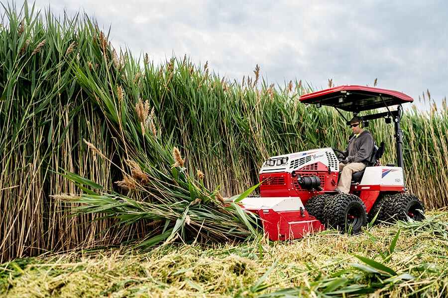 Ventrac 4520 tractor mowing through heavy brush