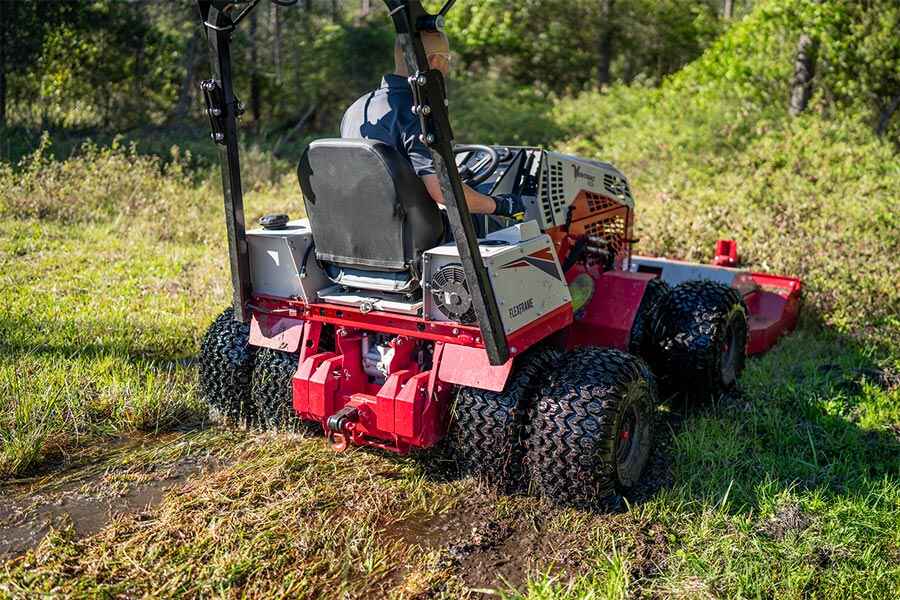 Ventrac 4520 tractor with dual wheels moving through wet grounds